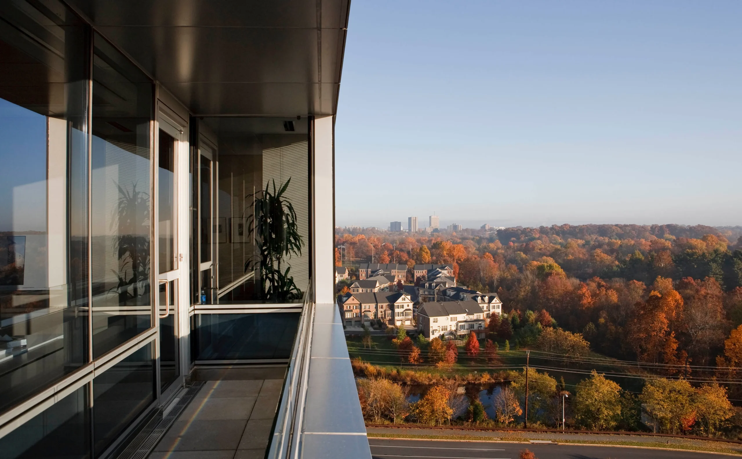 office balcony overlooking surrounding homes and fall trees