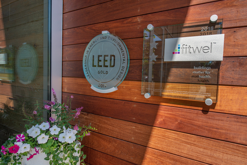 LEED Gold and fitwel plaques hanging on a wall