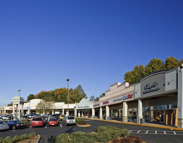 cars in the parking lot and store exteriors at Aspen Hill Shopping Center in Maryland