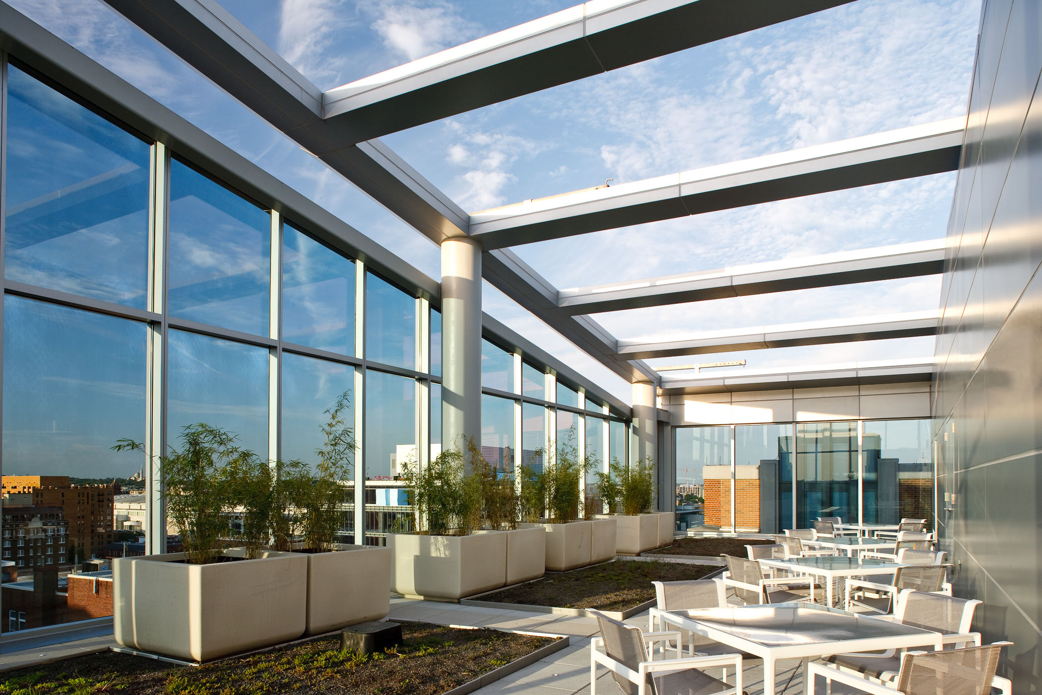 atrium area with dining tables and chairs and garden beds