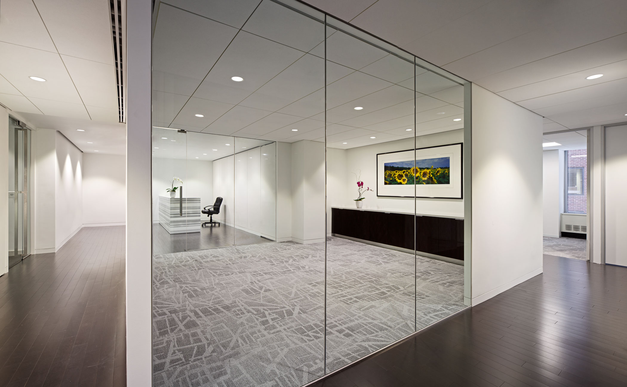 large mirrored wall with reflection of reception desk in it