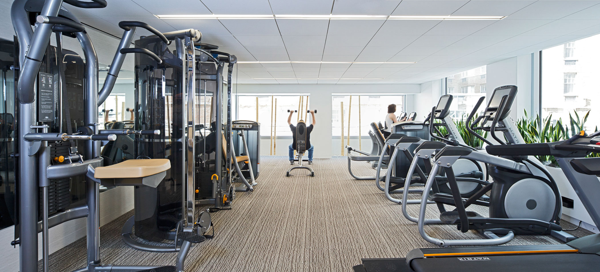 two people in an apartment building fitness center