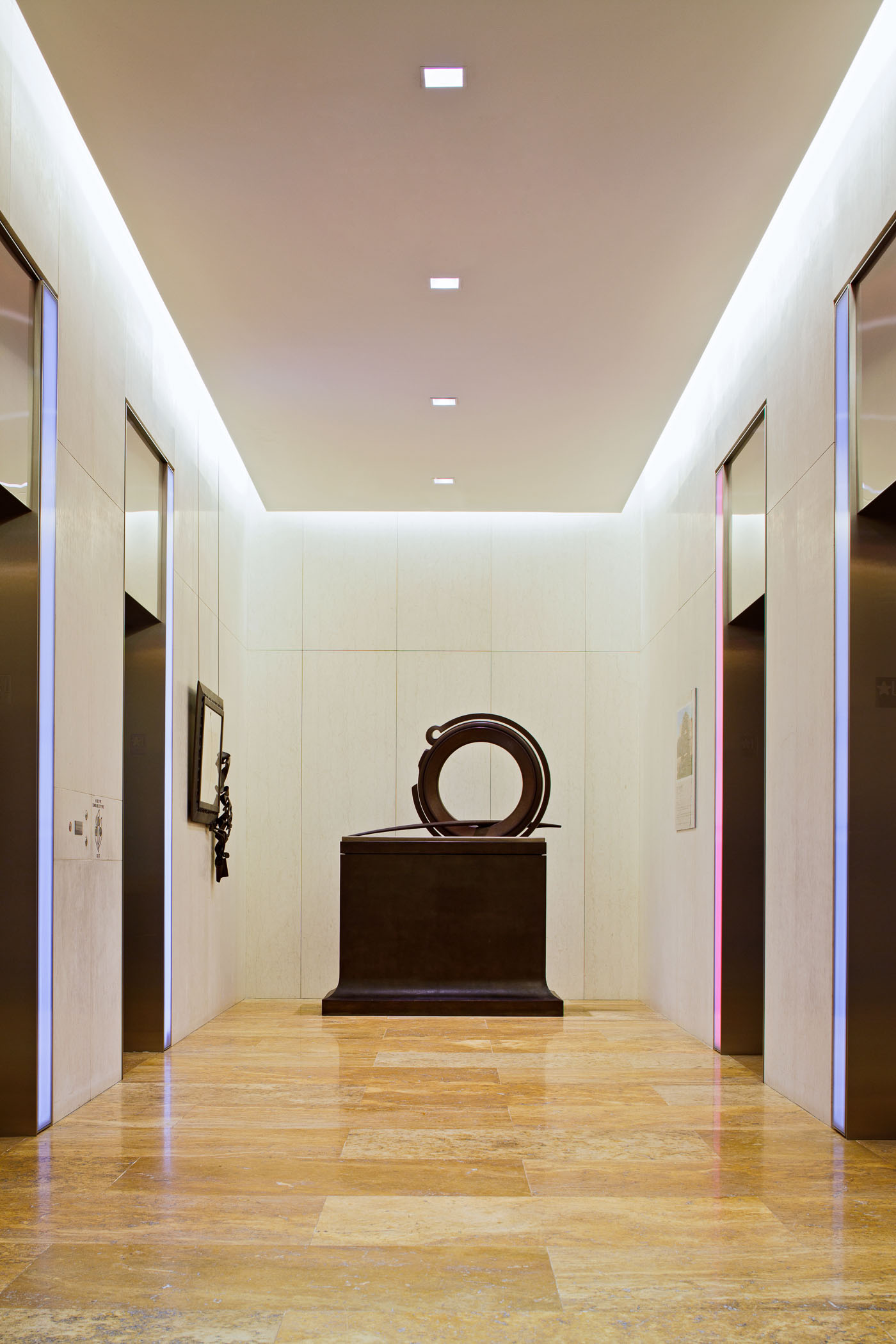 sculpture at the end of a hallway in an elevator bank