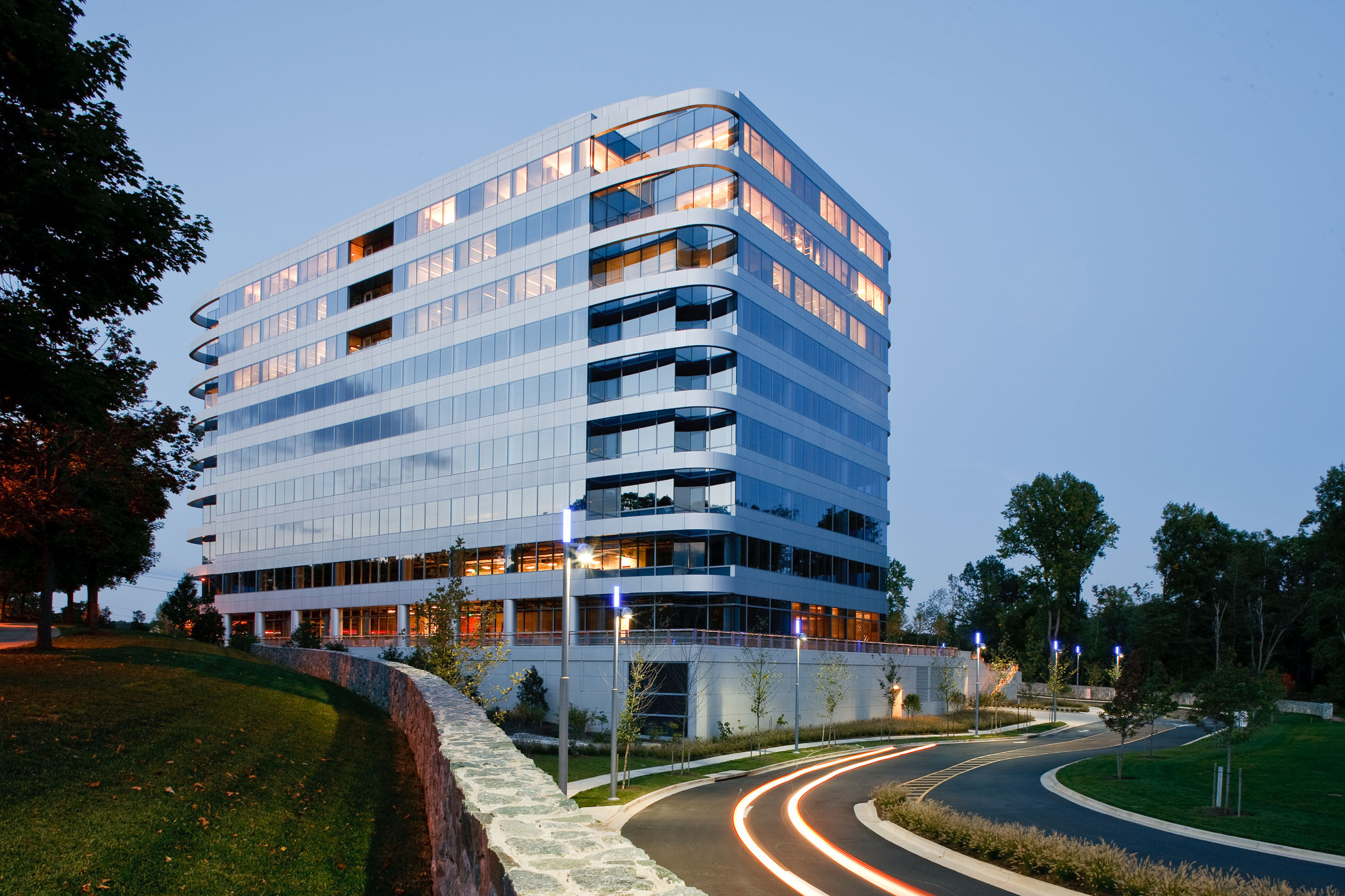 exterior of 2000 Tower Oaks and the road next to it at dusk