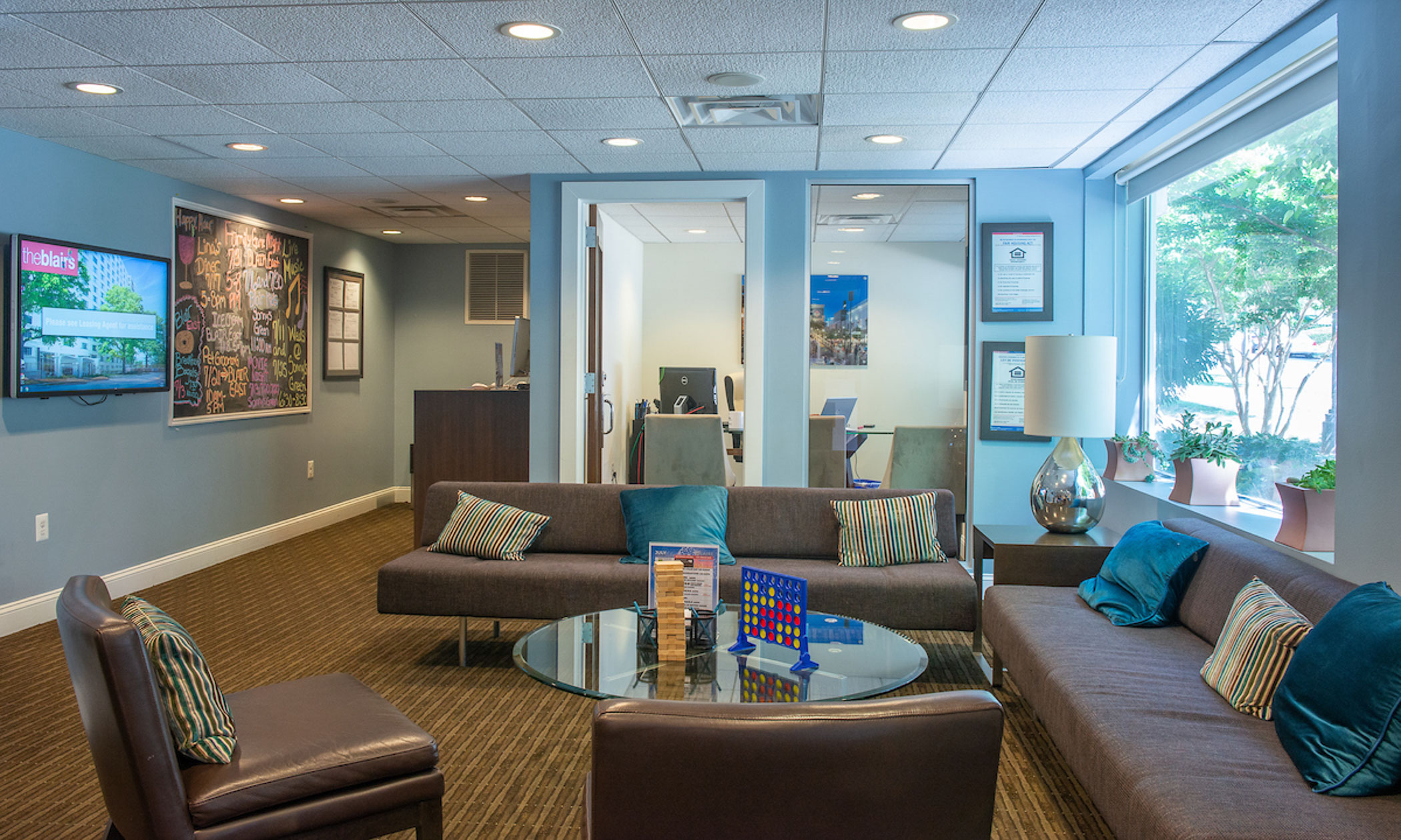 lounge area with two sofas, arm chairs and Jenga and Connect Four on the coffee table