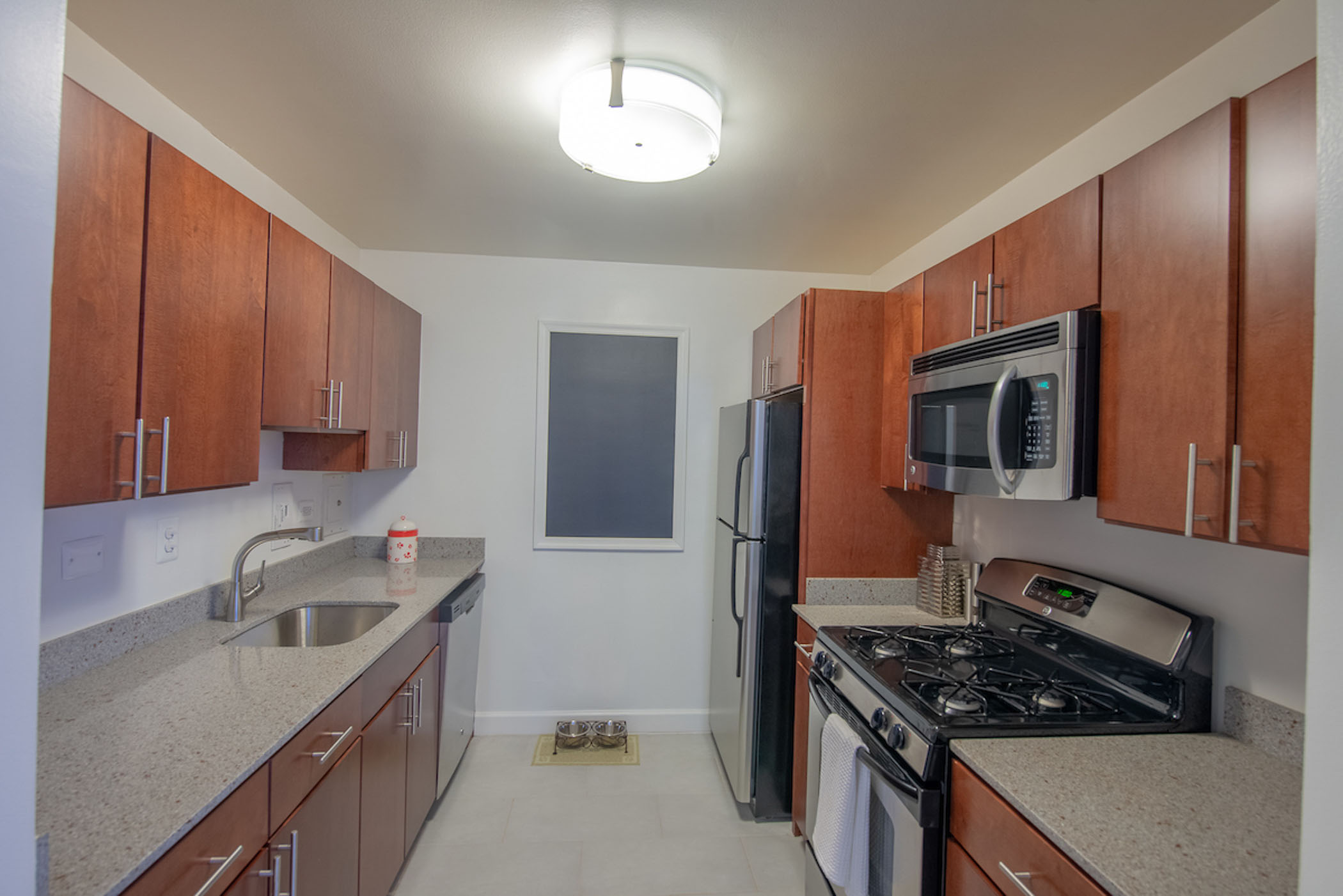 galley style kitchen with brown cabinets