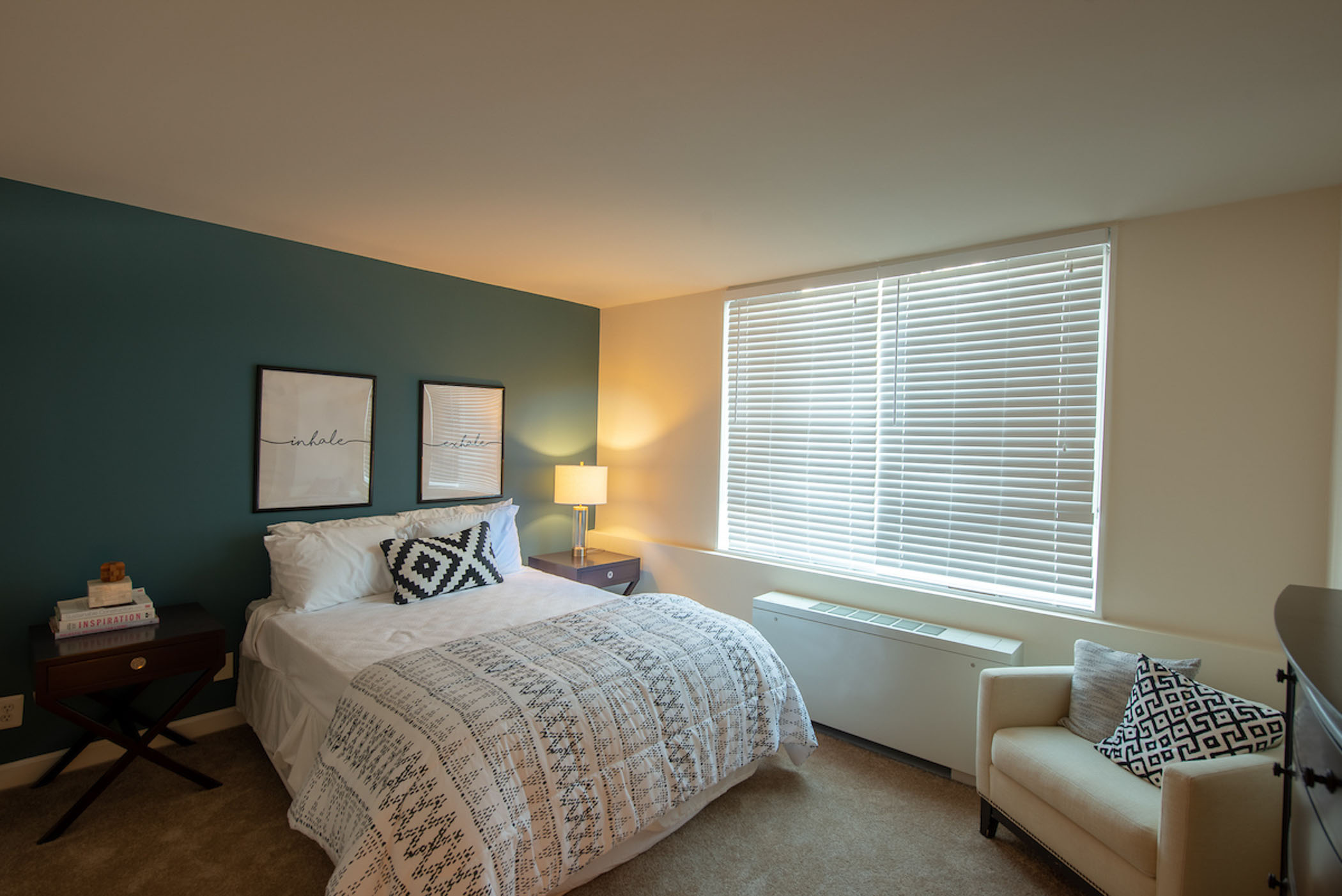 modern apartment bedroom with teal accent wall