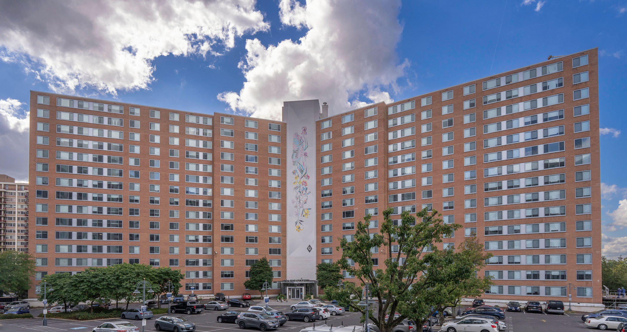 exterior of Blair Plaza and parking lot at The Blairs District apartments in Silver Spring, MD