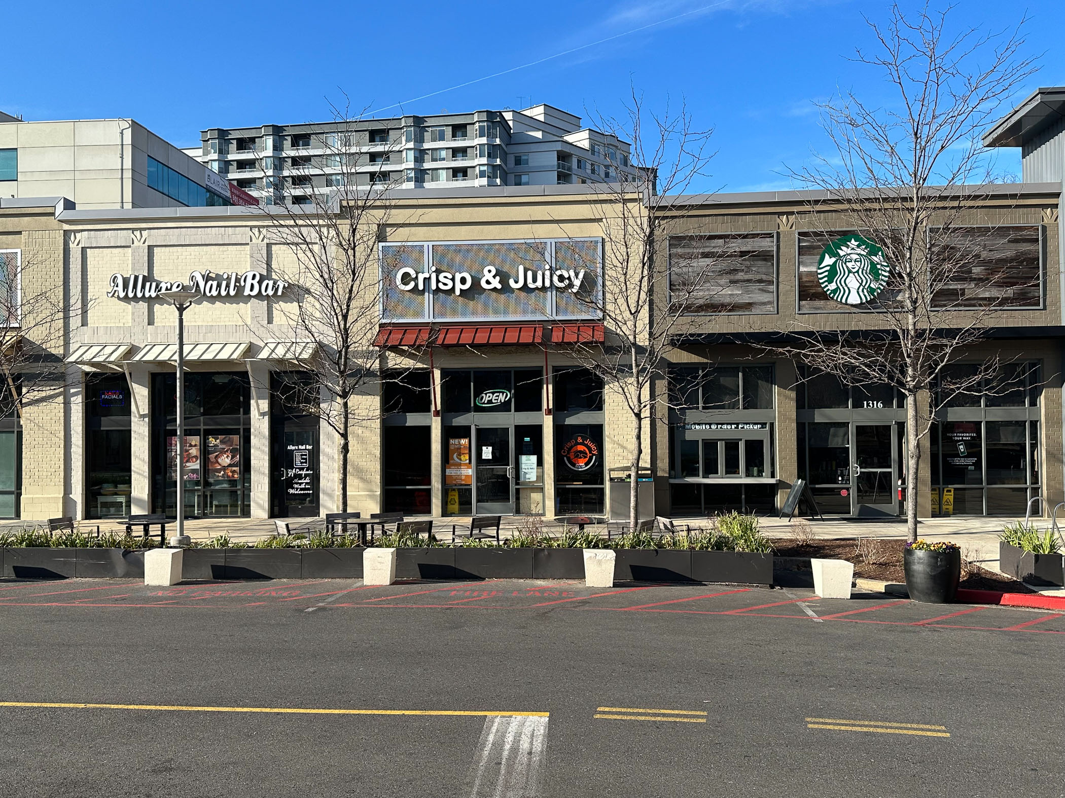 Allure Nail Bar, Crisp & Juicy, and Starbucks storefronts at The Blair District
