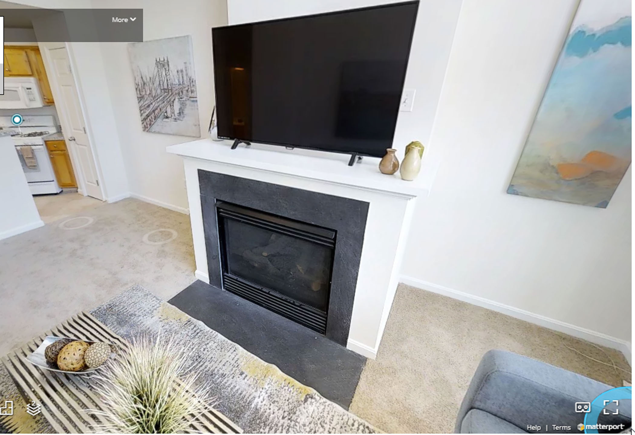 fireplace with flat screen TV on the mantle in an apartment living room