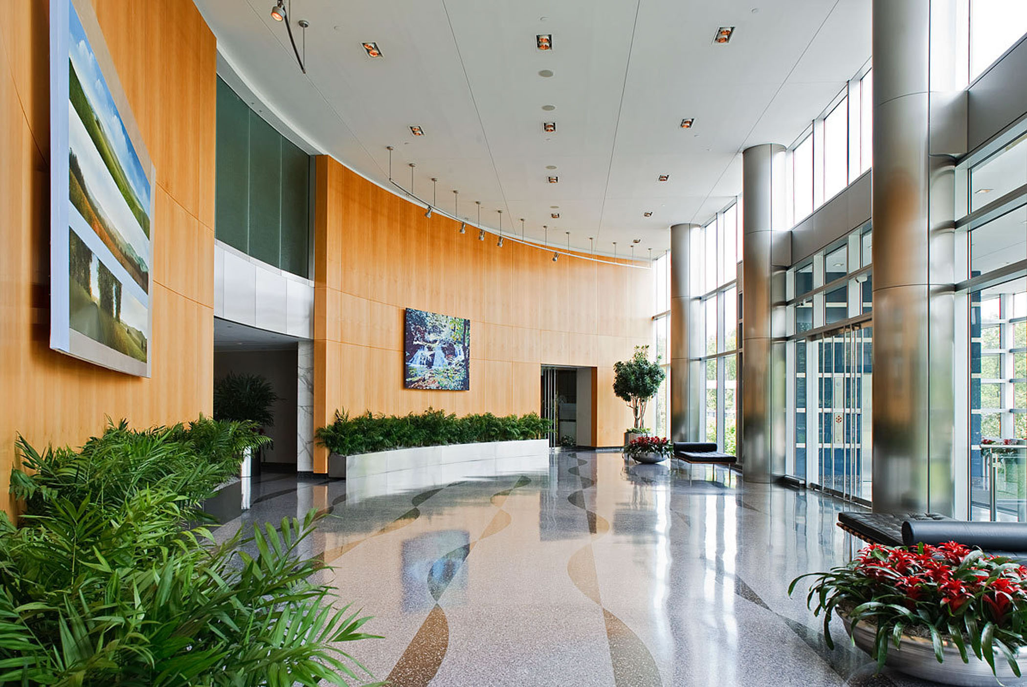 building lobby with greenery and two leather sofas
